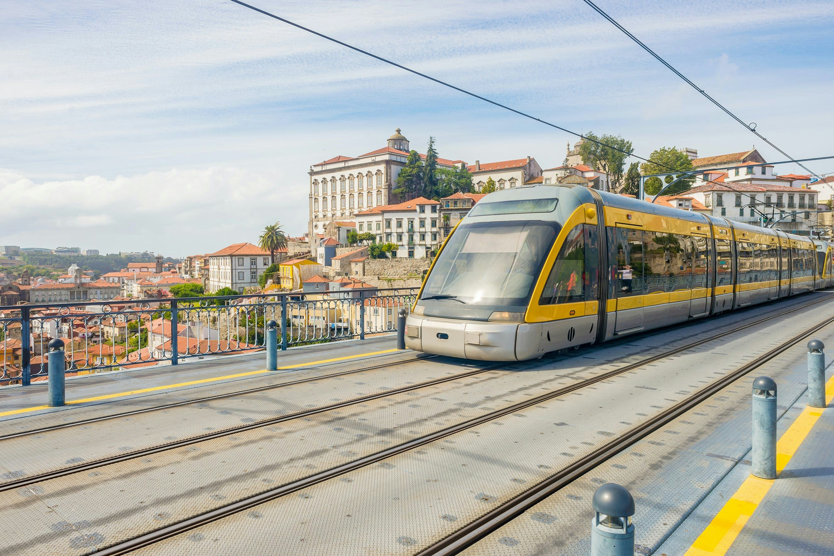 A photo of a tram crossing a bridge in Porto, Portugal