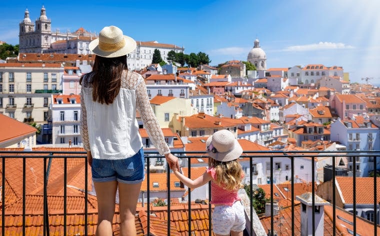 Woman and child overlooking the city of Lisbon from one of its viewpoints