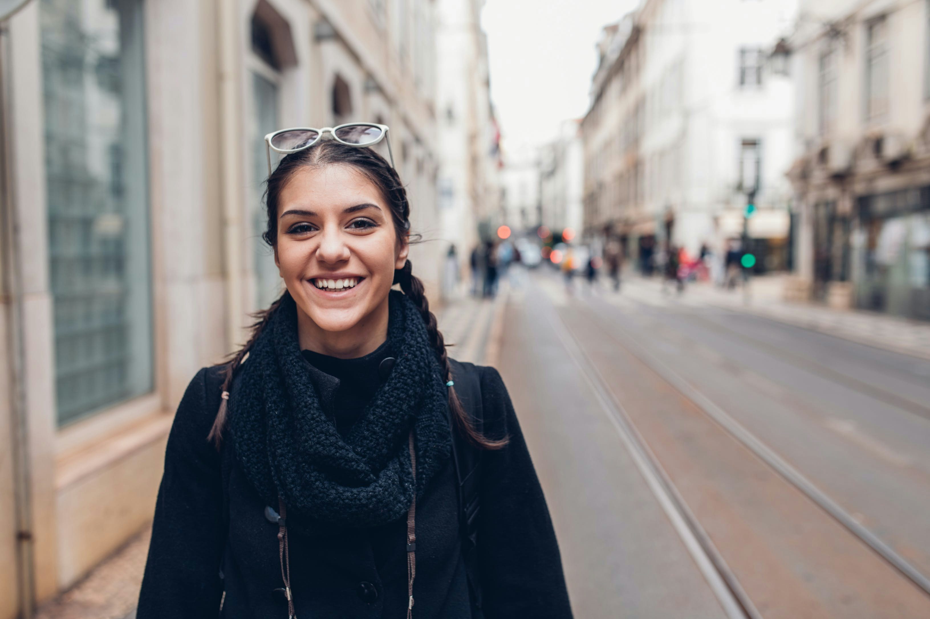A picture of a woman smiling on a city street